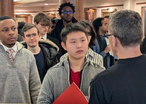 Group of students face forward listening to a speaker