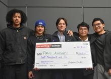 Group of student hold giant award check