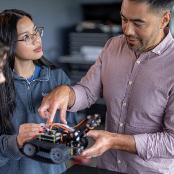 Professor works with a student's prototype